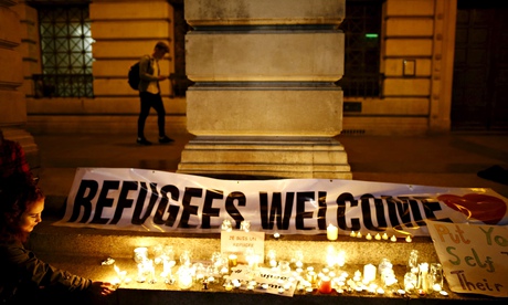 A woman lights a candle during a vigil for refugees in Nottingham