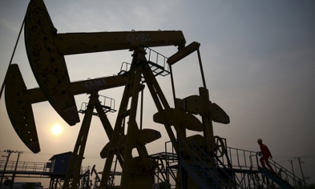 A worker examines a pumpjack at a PetroChina oil field in Panjin, Liaoning province.