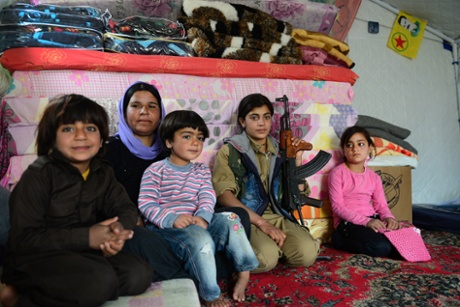 Yazidi fighter Mrali, 16, visits her mother and siblings living in a tent in the Sinjar mountains.
