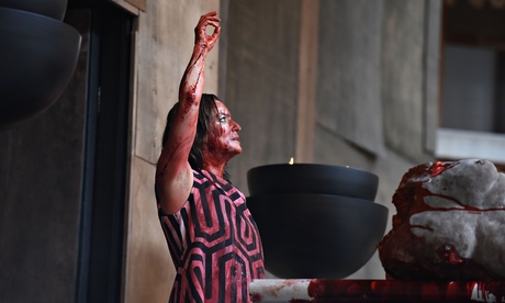 Katy Stephens's Clytemnestra raises a bloody arm