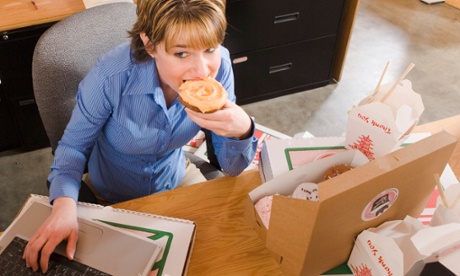 Woman eating at desk