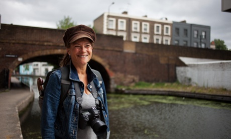 Cathy Teesdale photographed with her camera next to a canal, London