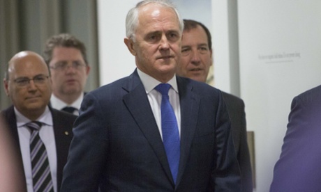 Minister Malcolm Turnbull walks with his supporters to the Liberal Party meeting that decided the party leadership. (AP Photo/Andrew Taylor)
