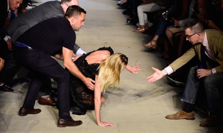 Model Candice Swanepoel takes a tumble on the Givenchy runway.