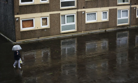 A woman walks through the Falinge Estate in Rochdale. MPs are voting on cuts to tax credits.