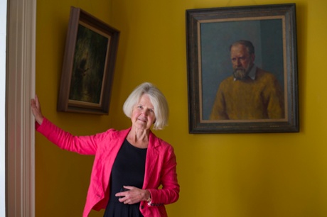 Judy Golding stands before a portrait of her Nobel prize-winning father at his former home in Cornwall.