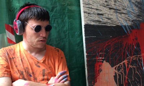 Sam Smith next to one of his splash paintings