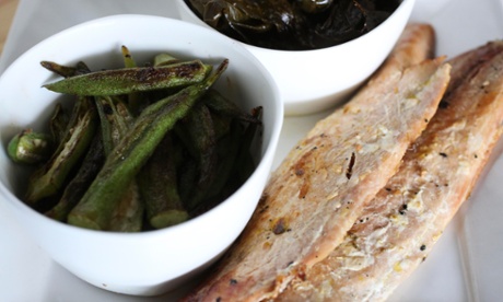 Hardwood smoked mullet, served with bacon braised greens and charred okra at Fodder and Shine in Tampa. The bacon braised greens are slow braised seasonal greens with house bacon, onion, sugar, pepper flake and apple cider vinegar.
