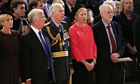 Jeremy Corbyn, right, stands for the national anthem during a Battle of Britain memorial service