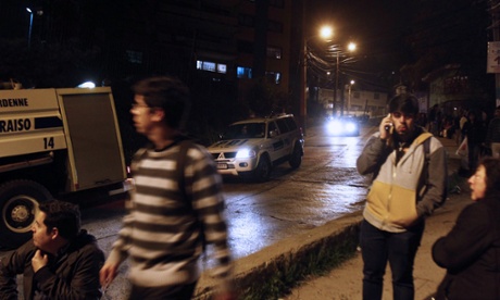 People remain in the street after a tsunami alert in Valparaiso