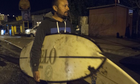 People recover their belongings after a large earthquake in Concon, some 110 kms northwest of Santiago on September 16, 2015.