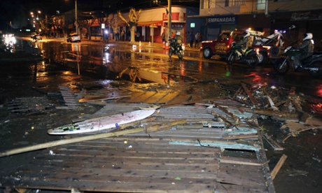 Police patrol a debris strewn street in Valparaiso, Chile, after a tsunami, caused by an earthquake hit the area, Wednesday, Sept. 16, 2015.