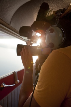 Man filming from small airplane
