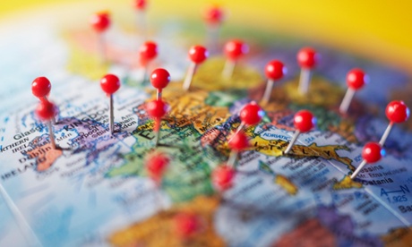 Map with push pins in various countries