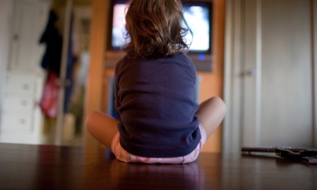 A young girl watches television.