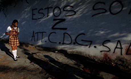 A girl looks at blood stains and a graffiti left by gunmen at a crime scene in Monterrey, Mexico. The graffiti reads: “These are Z, kindly CDG”, referring to rival drug cartels, the Zetas and the Gulf Cartel. 