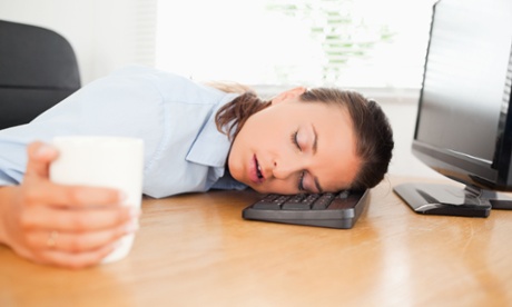A woman asleep at her desk
