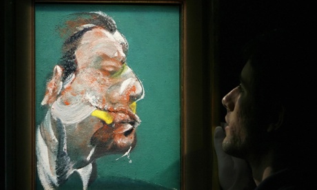 A member of Sotheby’s auction house adjusts a painting entitled ‘Study for Head of George Dyer’ (1967). The painting is valued in excess of £8m.