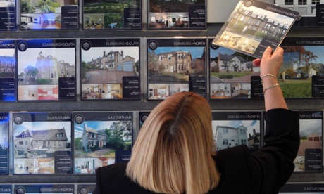 Woman looking at houses in an estate agents in Edinburgh. David Cheskin/PA Wire
