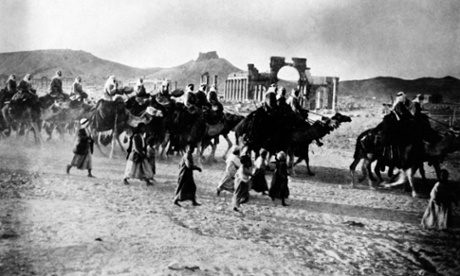 A caravan passes through the ruins of Palymra in the 1930s.