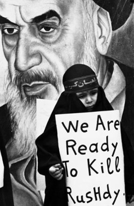 A girl in Beirut carries a sign vowing to kill author Salman Rushdie in February 1989.