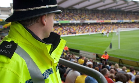 A special constable monitors the crowd.