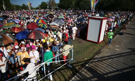 People gather in the Plaza de la Revolution for the arrival of Pope Francis
