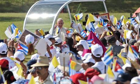 Pope Francis waves at the crowd as he arrives to give a morning mass at the Calixto Garcia square