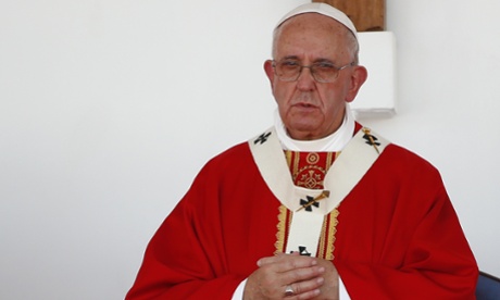 Pope Francis stands on the altar during Mass