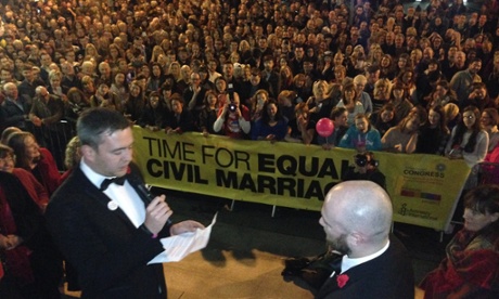 Malachai O'Hara (left) and Michael McCartan say their wedding vows before a crowd of hundreds in Belfast
