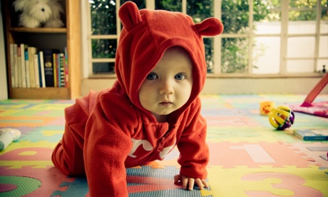 A baby crawling along the floor