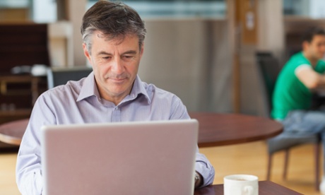 Man on laptop in coffee shop