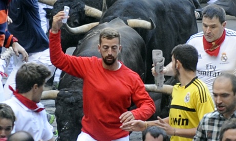 bull runs as man takes selfie