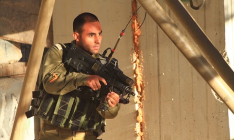 An Israeli soldier - reportedly an officer - approaches Hadeel from the left as she is speaking to a Palestinian man in a striped shirt who had apparently attempted to intervene to help her.