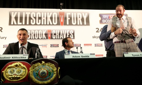 Tyson Fury (right) is restrained after Klitschko repeatedly calls him a 'clown'.