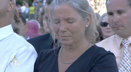 A woman in prayer at the canonization mass.