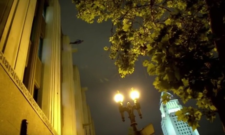 Dynamo walks down the side of the LA Times building.