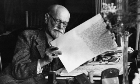 1930, Vienna, Austria --- Sigmund Freud, 1856-1939, Austrian psychiatrist, in the office of his Vienna home looking at a manuscript.