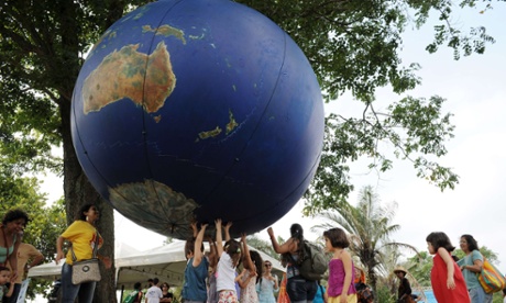 Children play with a giant globe at the People  s Summit in Flamengo park in the framework of the Rio+20 United Nations Conference on Sustainable Development in Rio de Janeiro, Brazil on June 17, 2012.