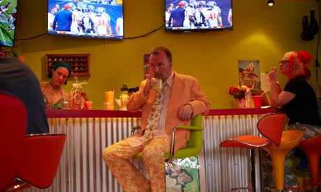 Stanhope has a drink and watches the football with friends in the Fun House.