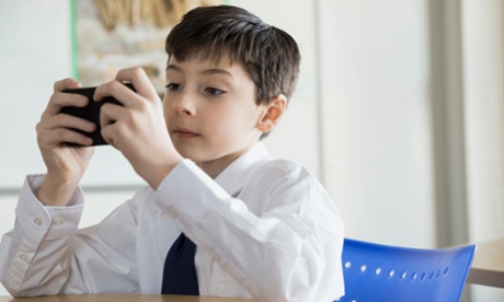 A school boy using his smartphone