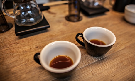 two cups of coffee on a table in a cafe
