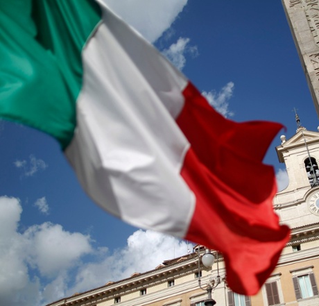 An Italian flag waves in front of the Montecitorio palace.