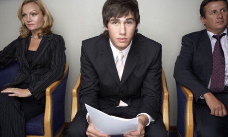 Job candidate dressed in suit holding CV