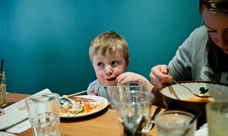Young boy eating in a restaurant