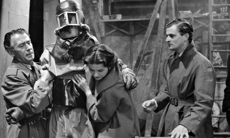 Quatermass (Reginald Tate, left) helps the dying astronaut Carroon in The Quatermass Experiment. Pho