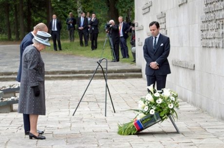 Queen Elizabeth II and the Duke of Edinburgh pay their respects to victims at the Bergen-Belsen concentration camp in Germany.