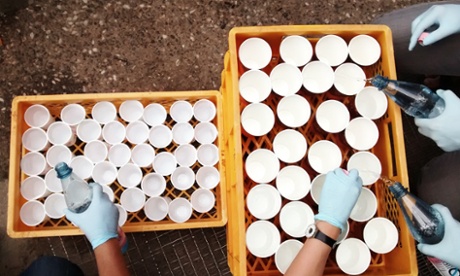 Handing out water to refugees at LAGeSo, Berlin