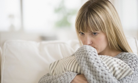 Woman sitting on sofa and thinking