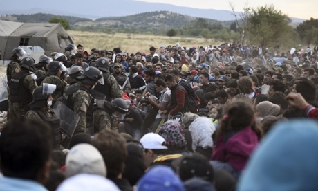 Refugees and migrants wait to pass the borders from the northern Greek village of Idomeni, to southern Macedonia, on 7 September 2015.
